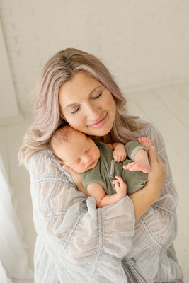 Mother holding her newborn baby during a studio session